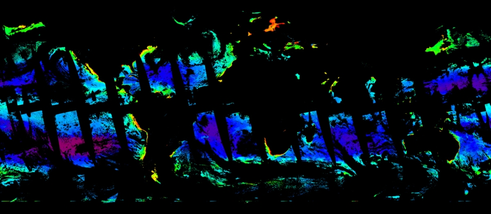 This is an image showing simulated chlorophyll concentrations in the ocean on March 21, 2022. The image has a black background. Regions colored in blue represent areas of low chlorophyll concentration, green are medium, and red areas have high levels. The image has strips of black running through the colored areas from the upper left to the lower right to show PACE’s orbital track around the globe and places across the ocean where it has not scanned.